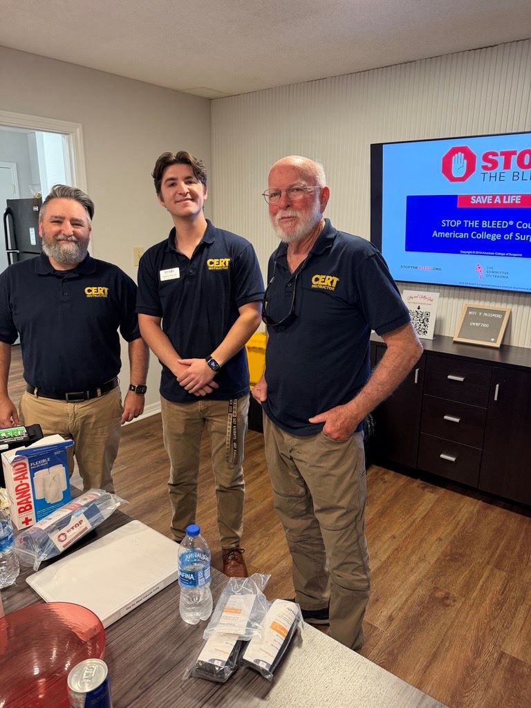 Three men standing together smiling.