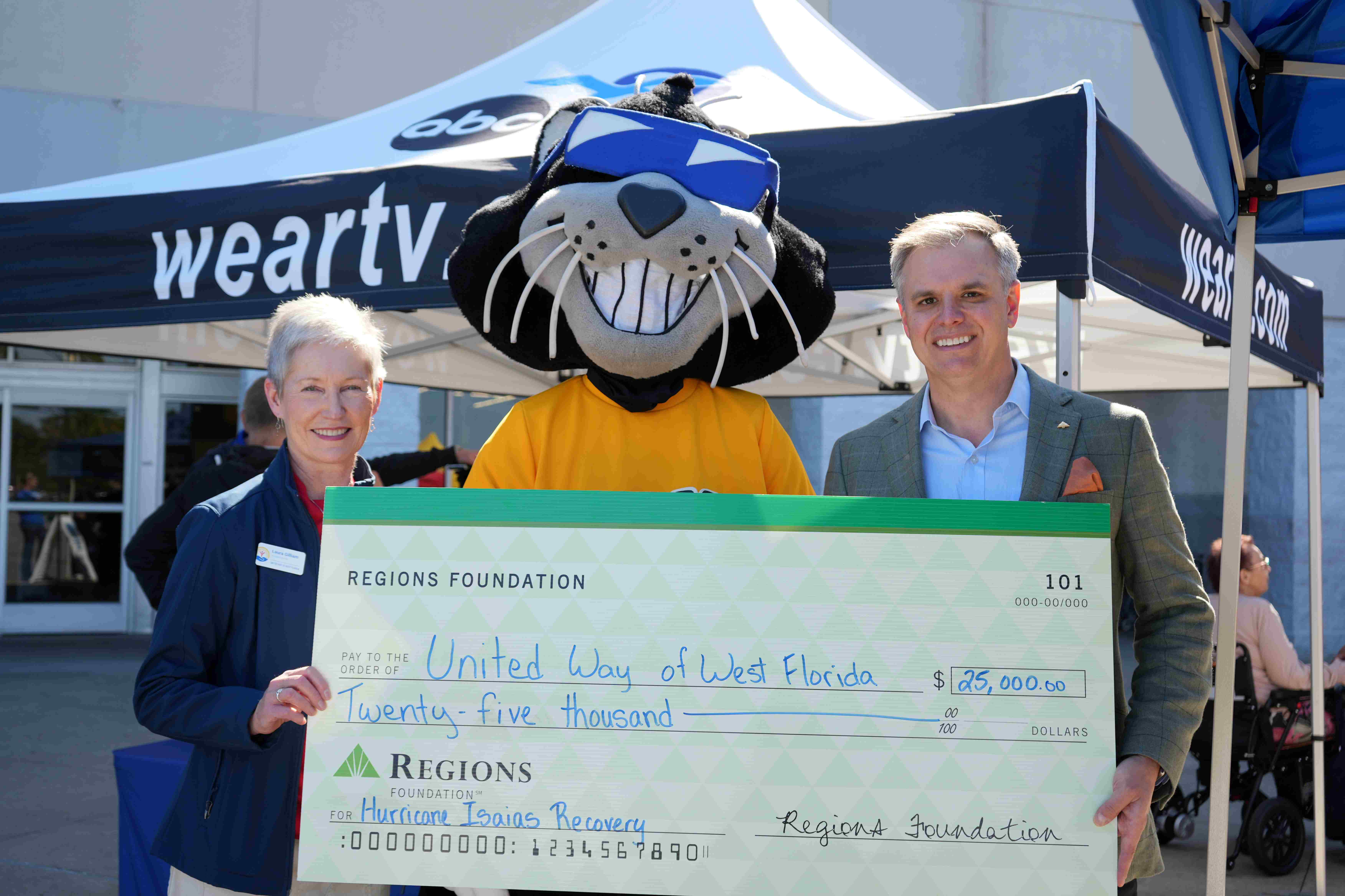 Laura Gilliam and Preston Forshee with a $25000 check from Regions bank.