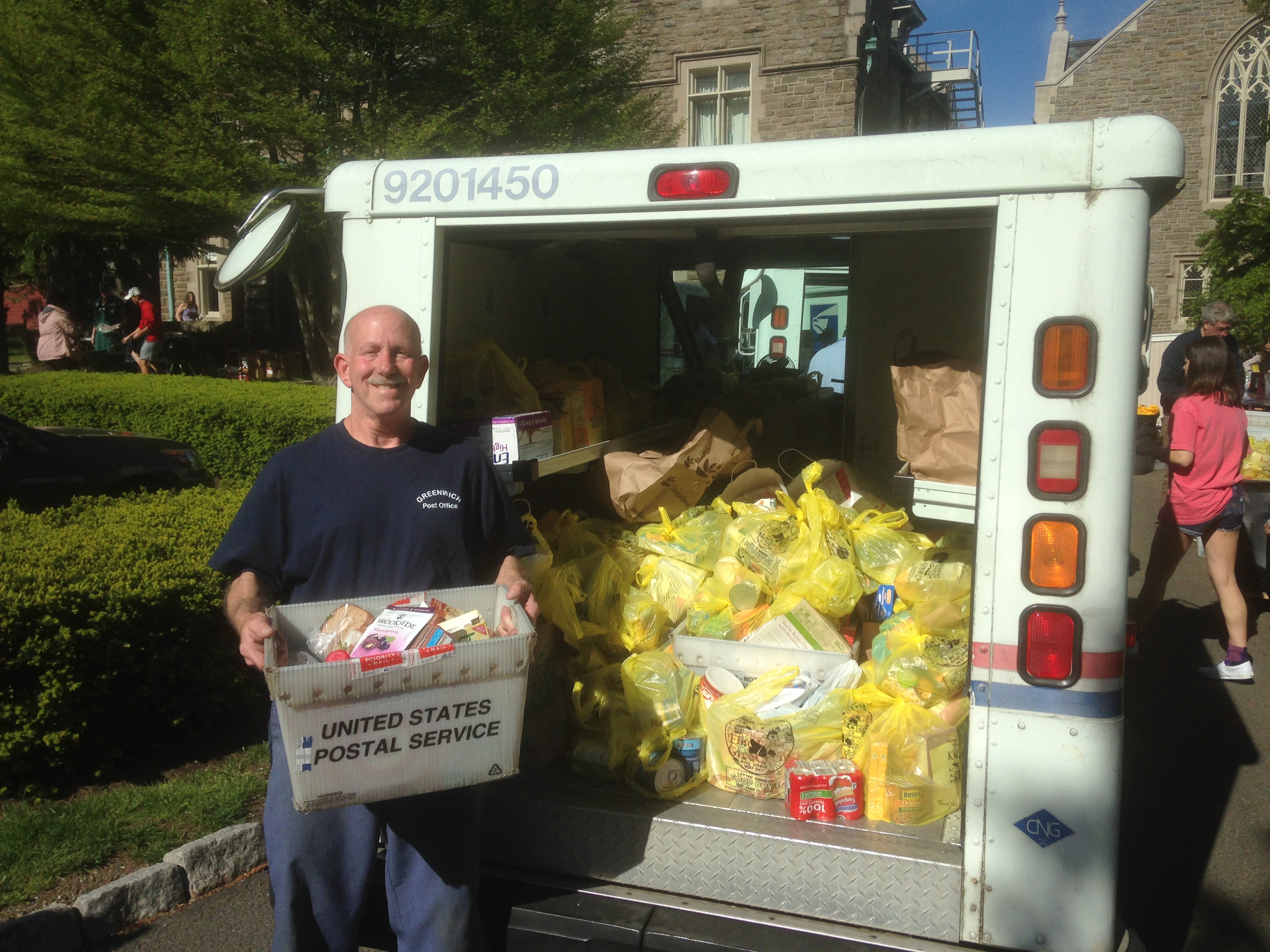 Photo of a letter carrier collects food donations