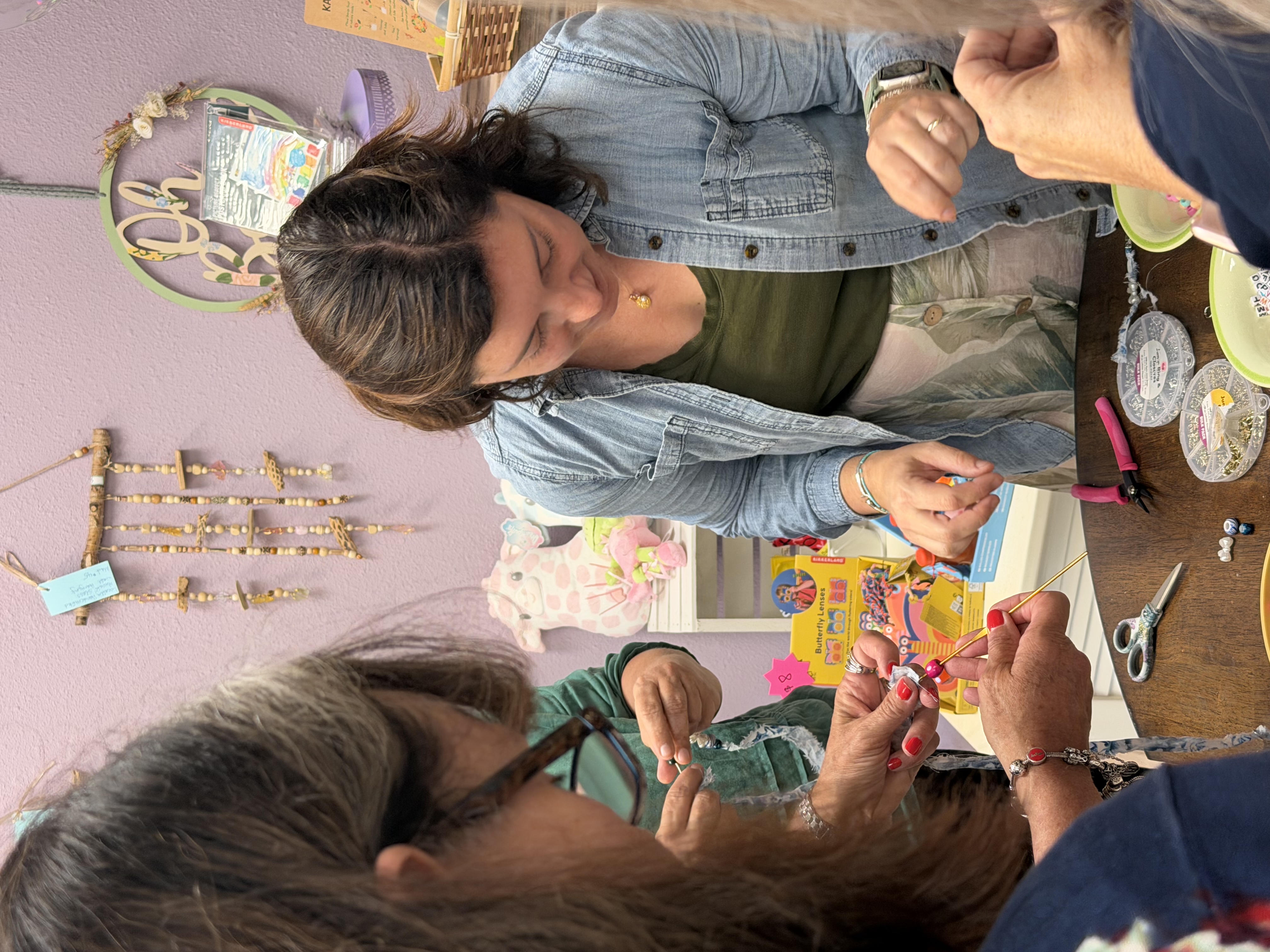 women making friendship bracelets