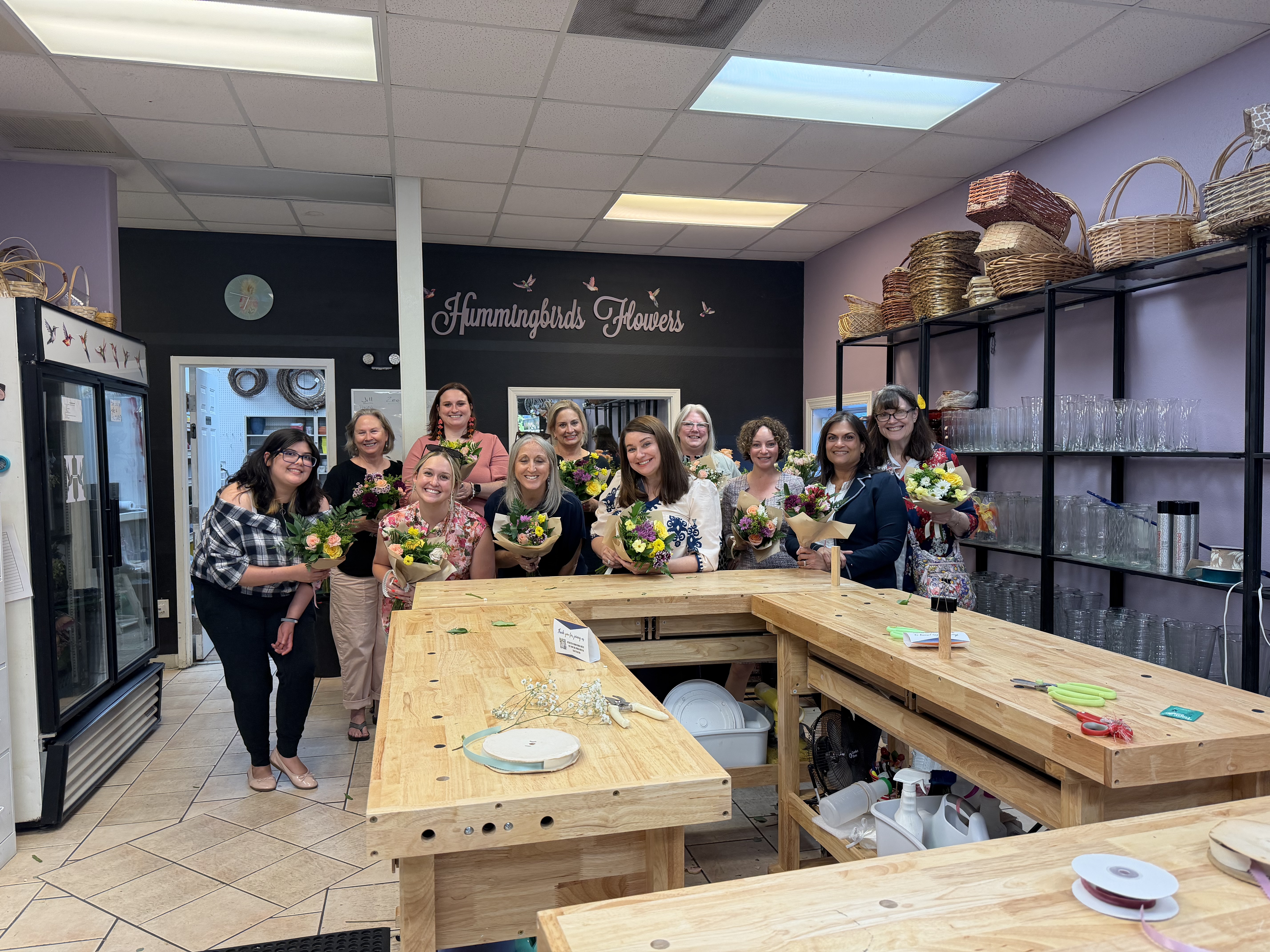 Group of women at books and bouquet event 