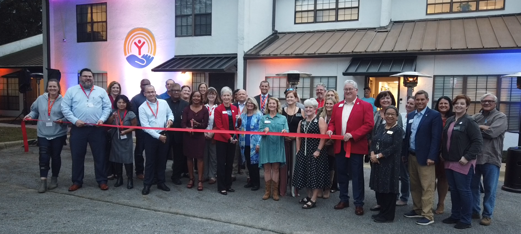 United Way of West Florida with local chambers in front of the new building doing a ribbon cutting