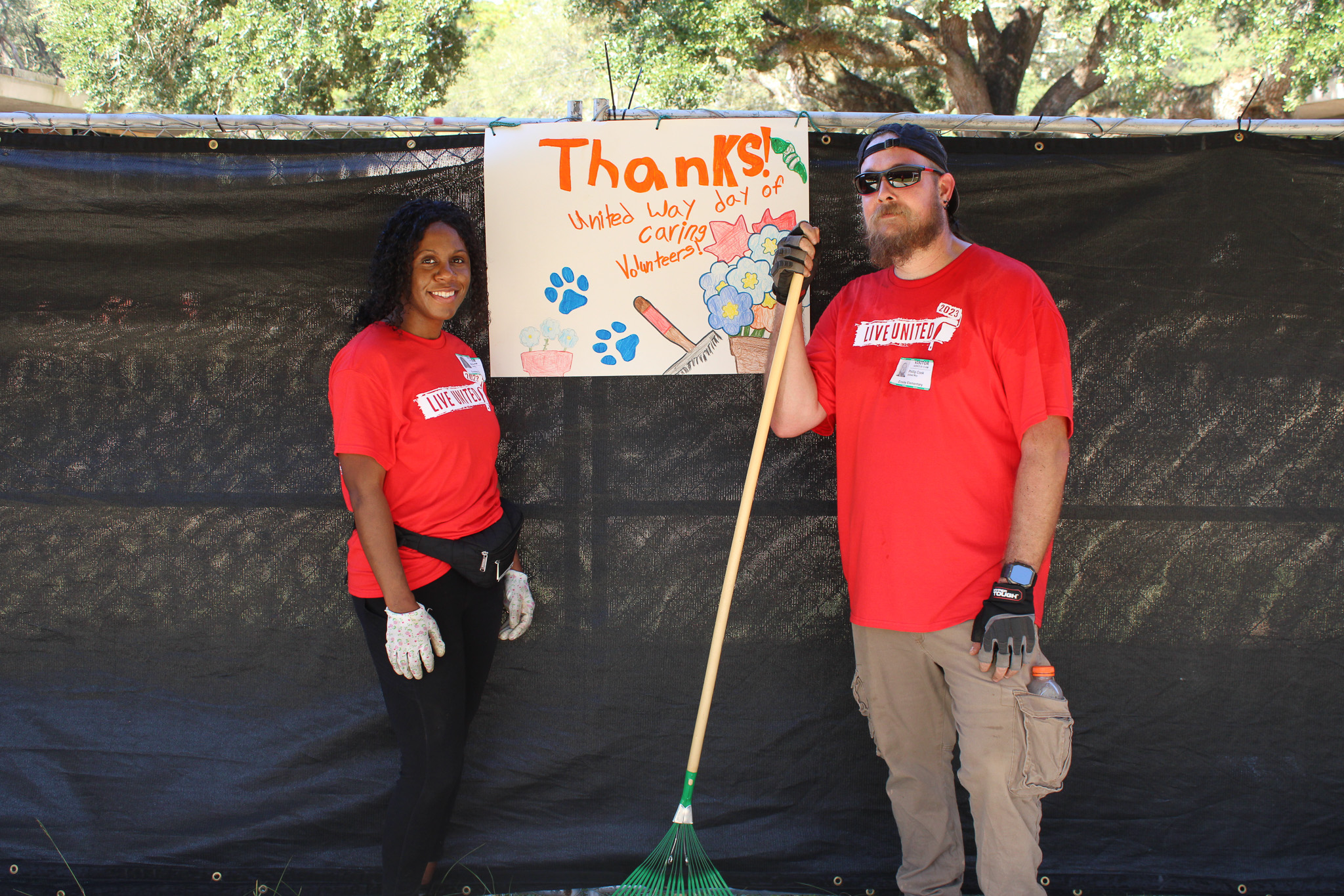 Navy Federal Volunteers at Ensley Elementary in front of thank you poster made by the students