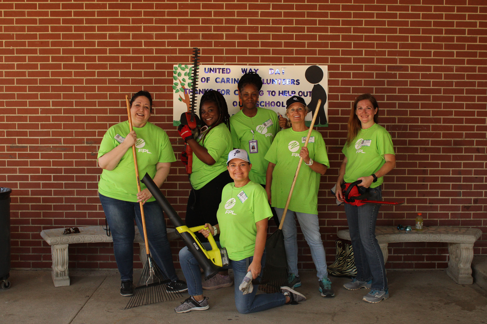 FPL Volunteers at Ensley Elementary in front of thank you poster made by the students