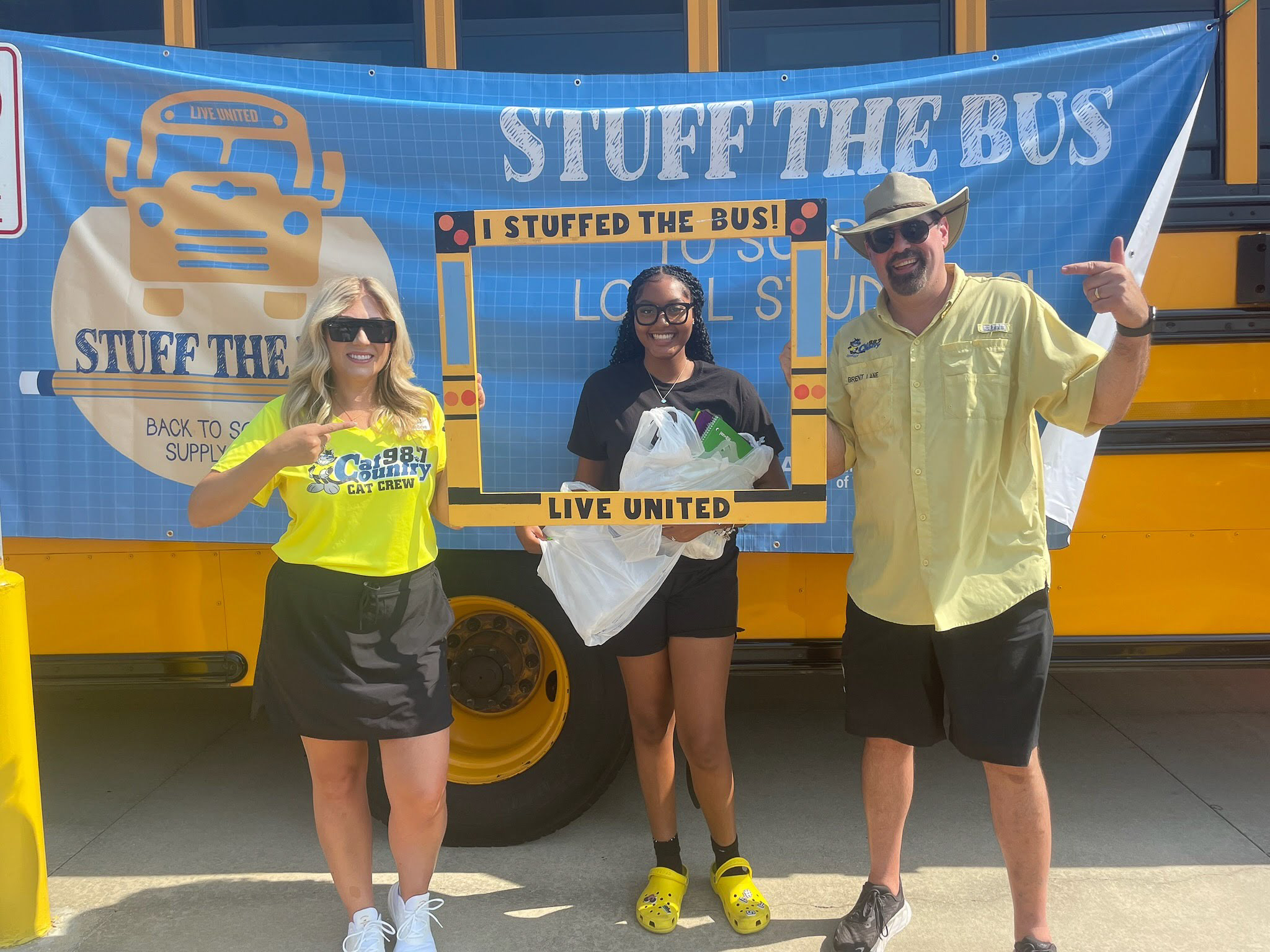 Cat Country employees in front of Stuff the Bus