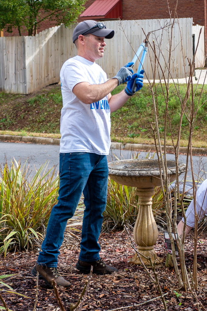 Volunteer trims bushes