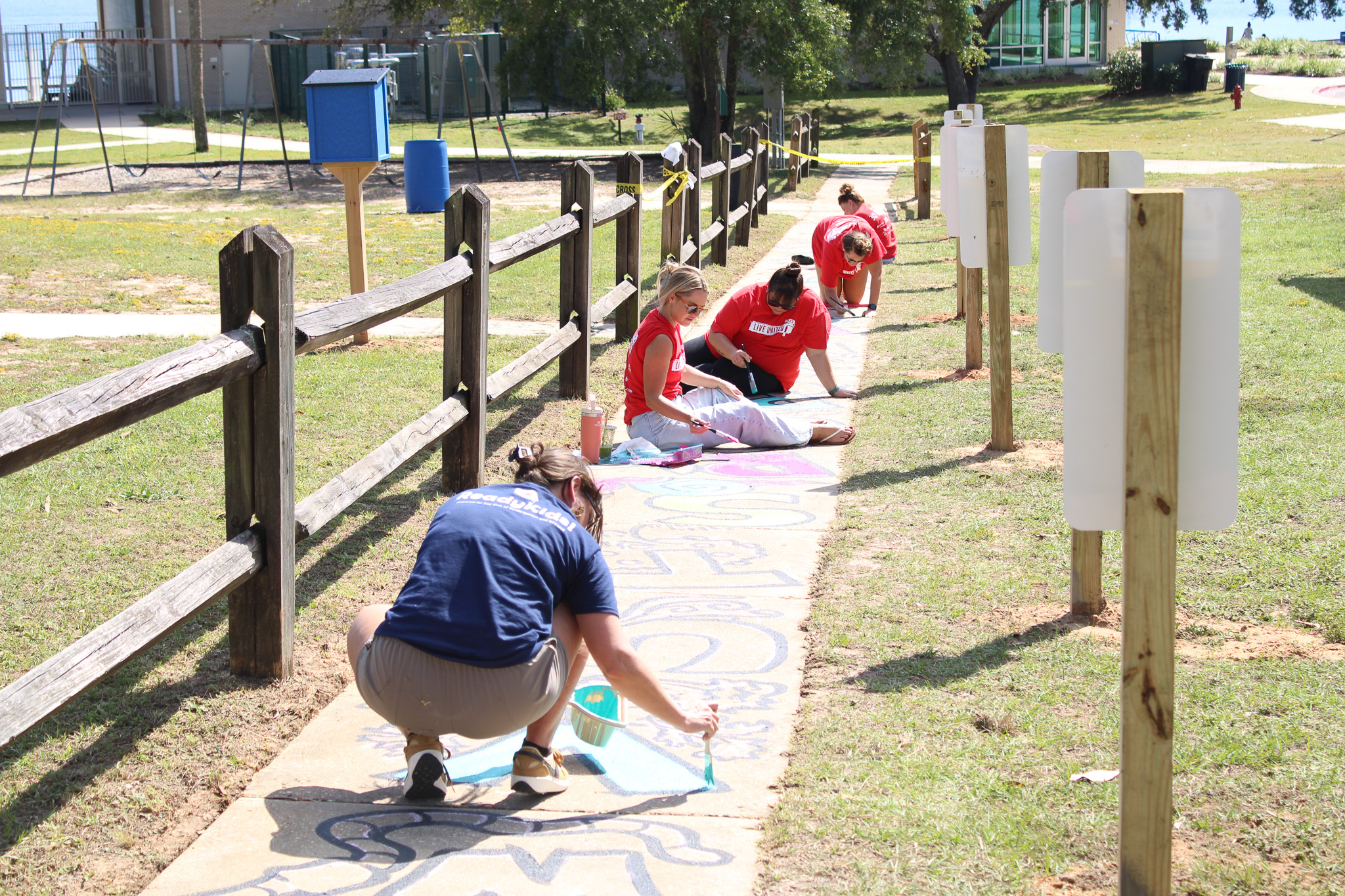 Pensacola News Journal volunteers at Born Learning Trail with ReadyKids!