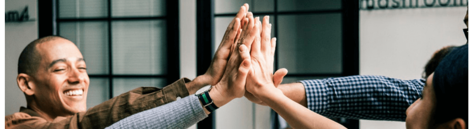Group of people high-fiving.