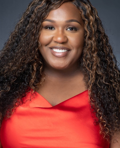 Woman smiling in a red shirt.