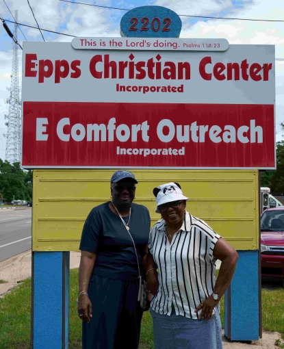 Pastor Tisdale and Annie standing in front of the Epps Christian Center sign.