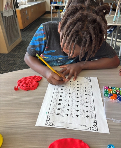 Boy working on a worksheet.