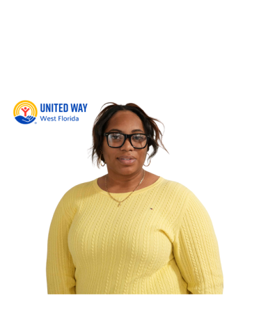 Girl in a yellow sweater smiling.